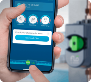 A Pronto Plumbing team member uses a smartphone app to monitor pressure, flow rate, and water temperature near service equipment.